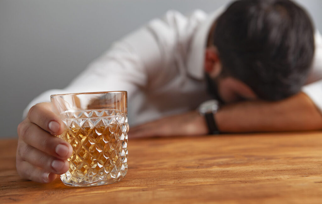 Passed out man showing early signs of alcoholism