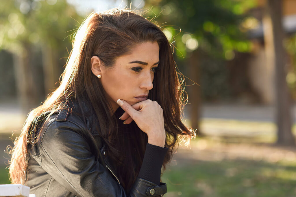 Woman sits and ponders the differences of hydrocodone vs oxycodone