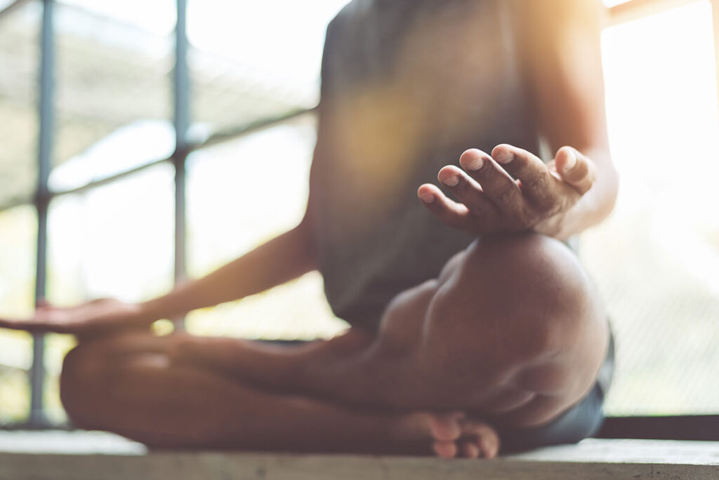 Woman doing yoga knows what is holistic therapy